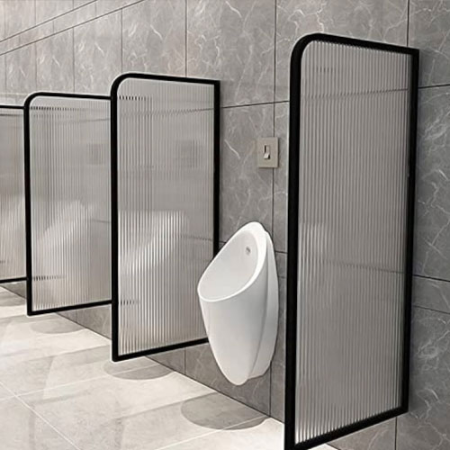 Glass toilet urinal partition in modern restroom